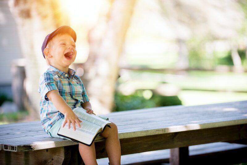 a child reading book and happy with a beautiful smile